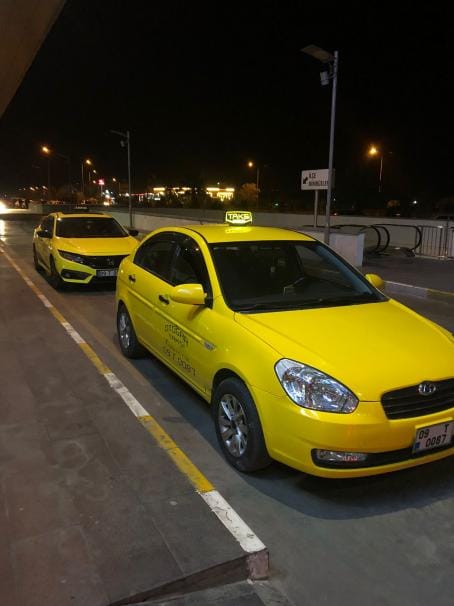 Aydın havalimanı transfer için gece terminal geliş alanında yolcu bekleyen sarı taksi